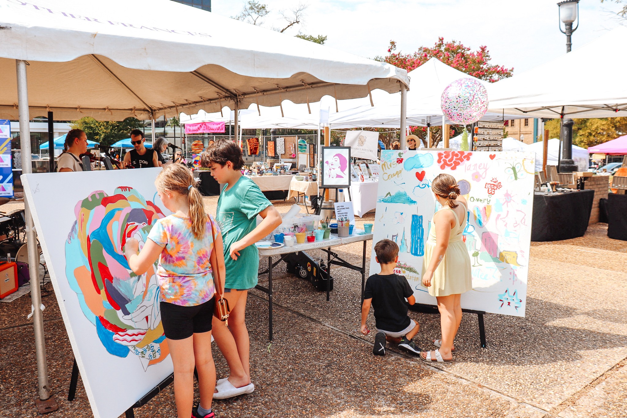 children painting at a tent